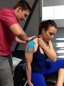 Dr. O'Neill applying Rocktape during Crossfit Open 2014.